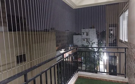 Invisible grill cables across an open apartment balcony