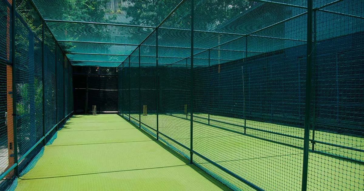 Netted cricket and sports practice lane with a steel frame